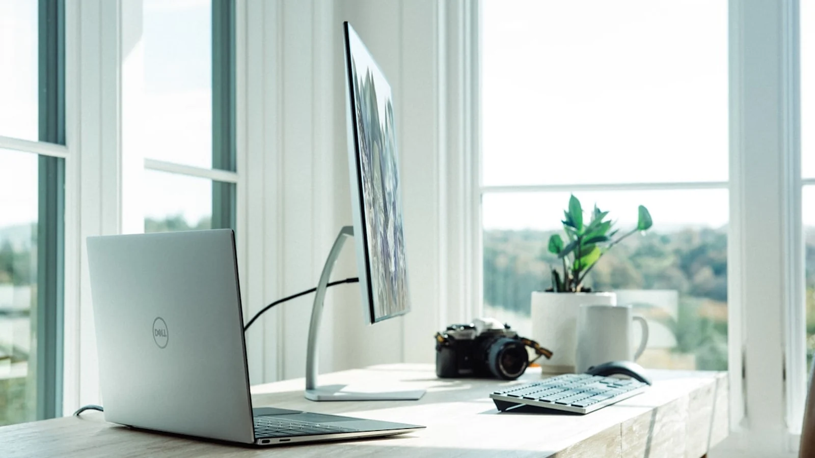 A modern Australian hybrid workspace showing tech professionals collaborating with remote colleagues via video screen